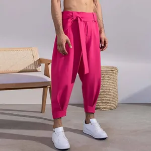 Detail of men's fuchsia cropped leisure pants featuring a unique waist tie design