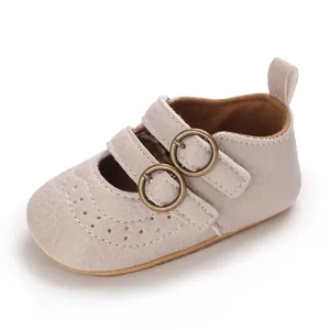 Infant soft sole Mary Jane shoes in beige with double circular buckle detail.
