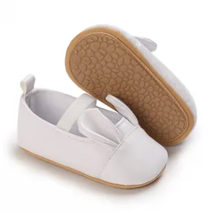 Detail view of white cartoon baby girl shoes with soft non-slip soles