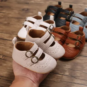 Close-up of soft-sole baby princess shoes with double buckles and wingtip detail