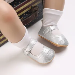 Close-up of silver baby girl walking shoes with glittery toe and buckle strap detail.