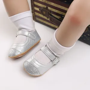 Detailed close-up view of silver glitter baby Mary Jane shoes with embossed patterns