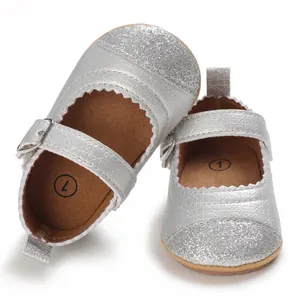 Close-up showing the silver glitter toe and textured strap of baby girl toddler shoes