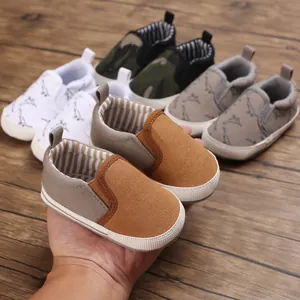 Detailed view of assorted baby walking shoes with soft soles and canvas texture.
