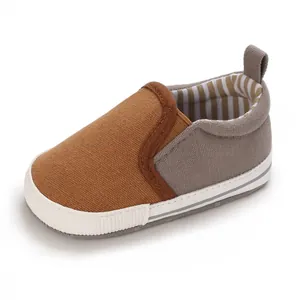 Close-up view of soft canvas baby pre-walker shoe in stylish brown and grey tones