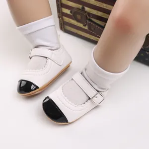 Elegant classic white baby Mary Janes with black toe cap and buckle strap for infant walkers