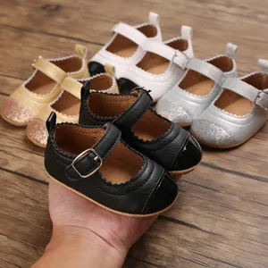 Close-up of black baby Mary Jane shoes with glitter details and buckle strap