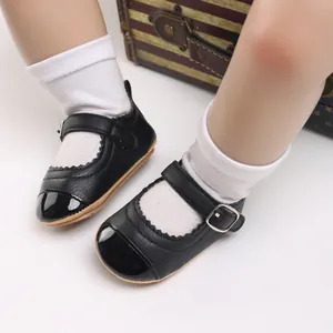 Detailed view of black Mary Jane baby shoes with soft rubber soles and buckle straps.