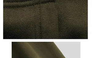 Makrodetail der hochwertigen Nähte am olivgrünen Streetstyle-Herrenumhangmantel