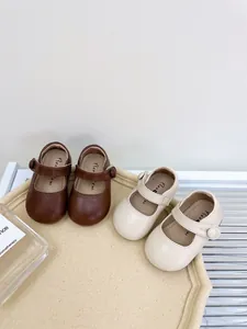 Detailed view of soft sole baby Mary Jane shoes in elegant brown and cream leather