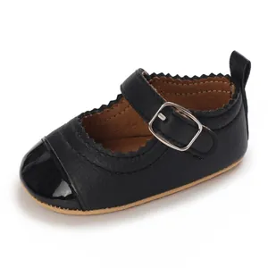 Close-up detail of black baby Mary Jane shoes with glossy toe and soft non-slip sole