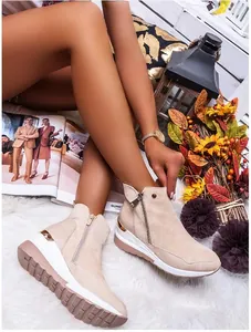 Beige faux suede high-top wedge ankle boots featuring side zipper and gold heel accent