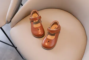 Classic brown girls' Mary Jane leather shoes featuring heart cutout and velcro strap detail
