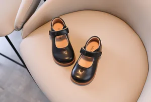 Detail top view of black children's Mary Jane shoes featuring cute heart cutout and soft sole