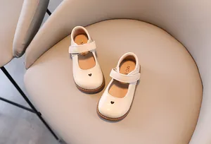 Detail view of white girls' Mary Jane leather shoes featuring a delicate small heart cutout