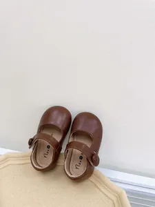 Close-up of brown soft-sole toddler Mary Jane shoes for baby girls, autumn leather shoes