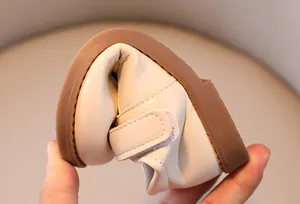 Macro detail showing the extreme flexibility and soft sole of the toddler walking shoe.