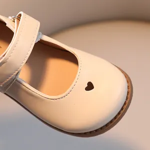 Elegant cream kids Mary Jane shoes featuring a cute heart cutout and comfortable soft sole