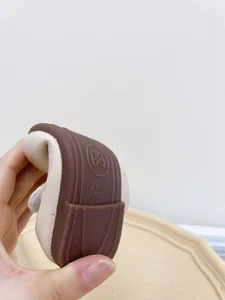 Close-up showing the flexible rubber sole of toddler girl soft leather walking shoes