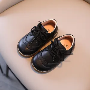 Close-up top view of classic black leather brogue shoes with decorative perforation