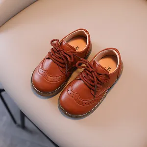 Vintage brown leather Brogue shoes for children with perforated details and lace-up design