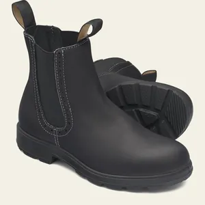 Primer plano de botas Chelsea negras para mujer con elegantes detalles brogue