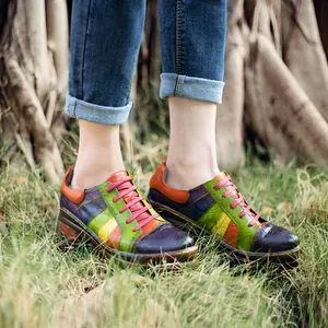 Close-up of colorful spliced genuine leather shoes with intricate floral embossing details