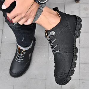 Detailed view of men's black hand-stitched leather Martin boots in outdoor casual style