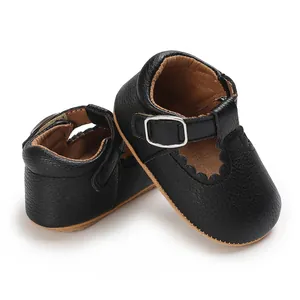 Detail view of black soft-sole baby princess shoes with elegant scalloped edge design