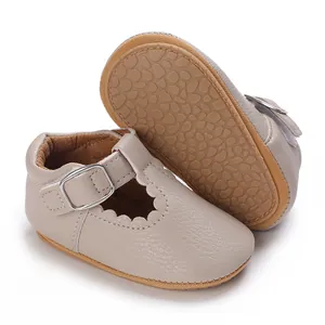Detail of beige baby princess shoes with soft anti-slip soles and scalloped T-strap