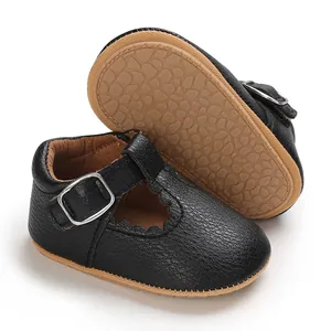 Close-up of black baby Mary Jane shoes with soft scalloped edges and pebble sole