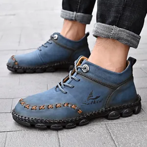 Durable blue men's mid-top Martin boots featuring unique handmade stitching details