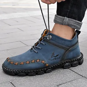 High-quality detail of blue hand-stitched men's mid-top outdoor casual work boots