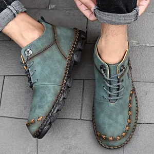 Top view of hand-stitched men's teal Martin boots with vintage leather texture