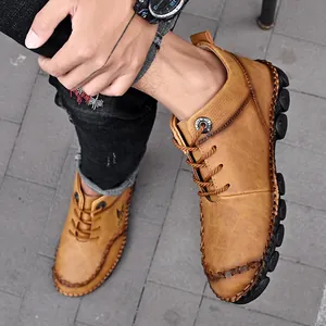 Detailed view of handmade brown mid-top leather Martin boots for men with stitching