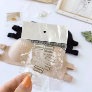 Detail view of replacement bra strap hooks and adjusters in clear plastic packaging