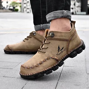 Macro detail of men's hand-stitched mid-top Martin boots in durable brown leather