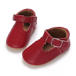 Detail view of red baby Mary Jane shoes with soft sole and scalloped edge design.