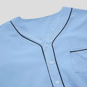 Close-up detail of light blue men's lounge robe with contrast piping and pocket