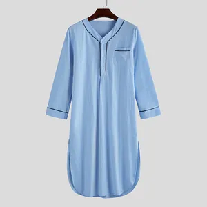 Detailed view of men's blue nightshirt featuring V-neck buttons and pocket piping.