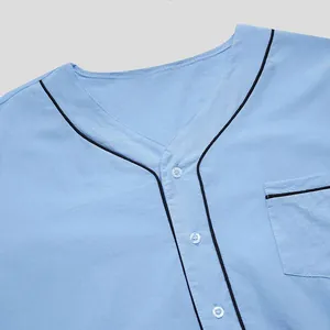 Detailed view of light blue men's loungewear neckline featuring black contrast piping