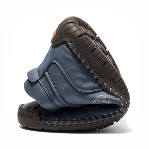 Flexible navy blue hand-stitched leather Martin boot demonstrating sole durability