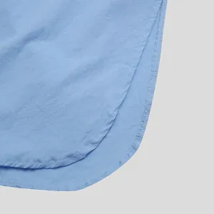 Close-up of neat stitching and hem on a light blue men's lounge robe