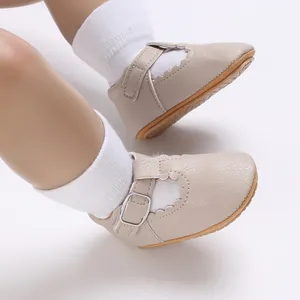 Detailed close-up of beige baby princess shoes featuring scalloped edges and soft soles