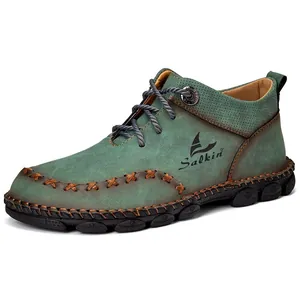 Detail view of green handmade stitched mens mid-top Martin boots with Salkin logo