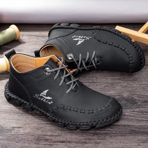 Macro view of black leather Martin boots with hand-sewn stitching and Salkin branding.
