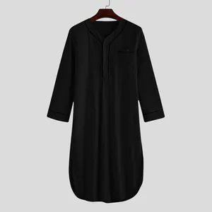 Front view detail of a men's long-sleeve black cotton nightshirt with a Henley neckline.