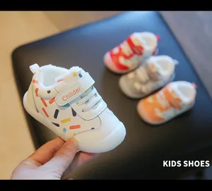 Close-up of white toddler winter shoes featuring warm fleece lining and a colorful sprinkle pattern