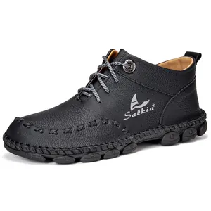 Side view of men's black handmade mid-top Martin boots with textured leather