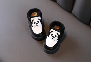 Top-down detail of black and white panda-themed baby winter snow boots with warm fur